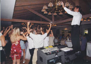 Paul up on his gear with a packed dance floor, guests cheering with arms raised