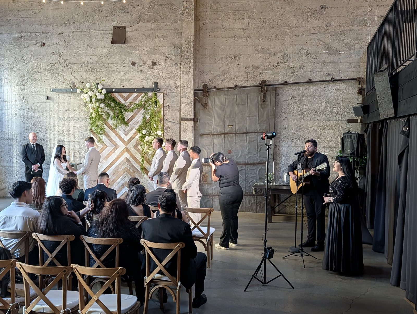 Wedding ceremony with live musicians on microphones at the Luce Loft in downtown San Diego