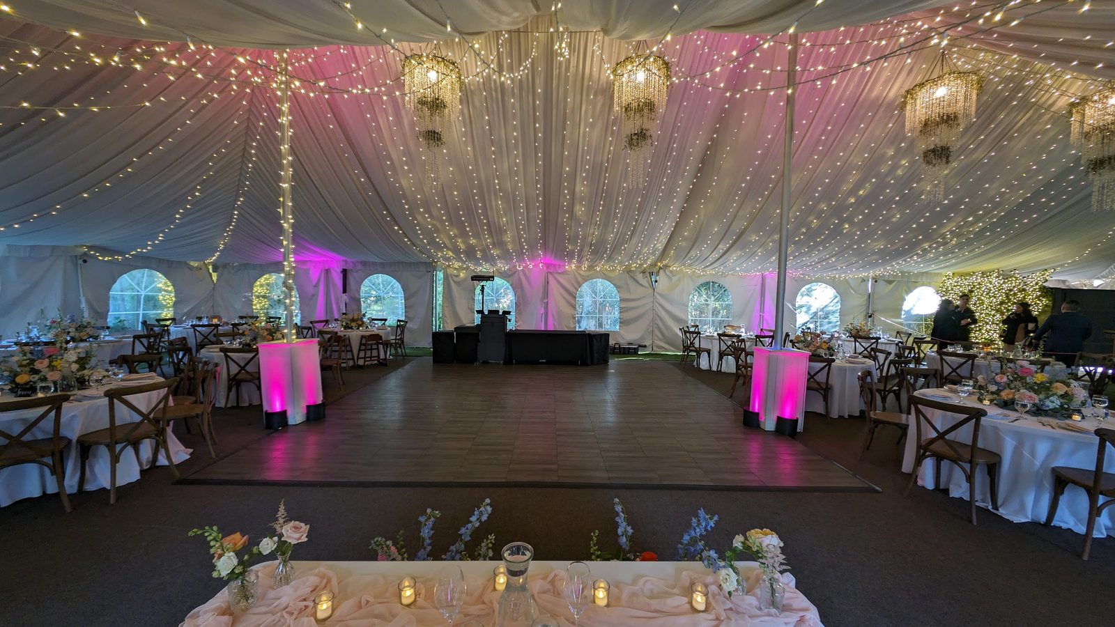 Reception tent with pink uplighting and twinkle lights at Twin Oaks House & Gardens in San Marcos