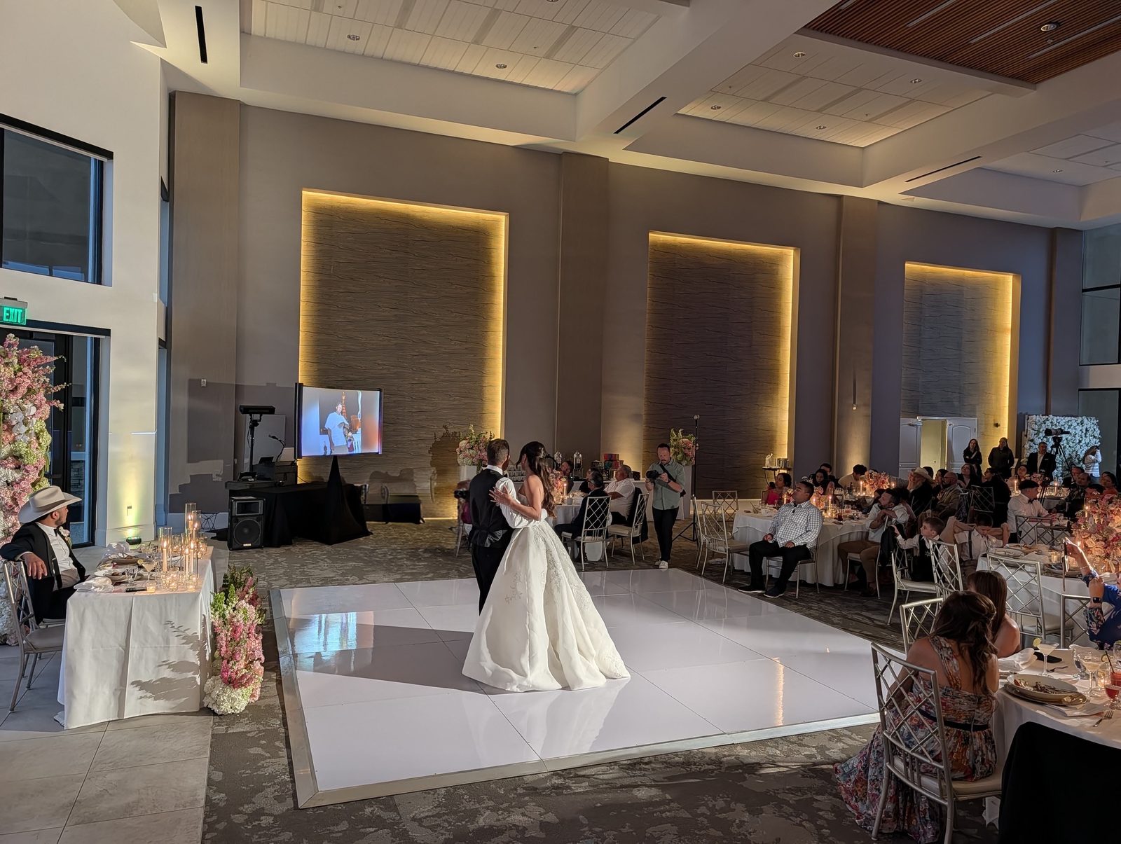 Bride and groom's first dance with a big-screen slideshow at the Westin Carlsbad ballroom